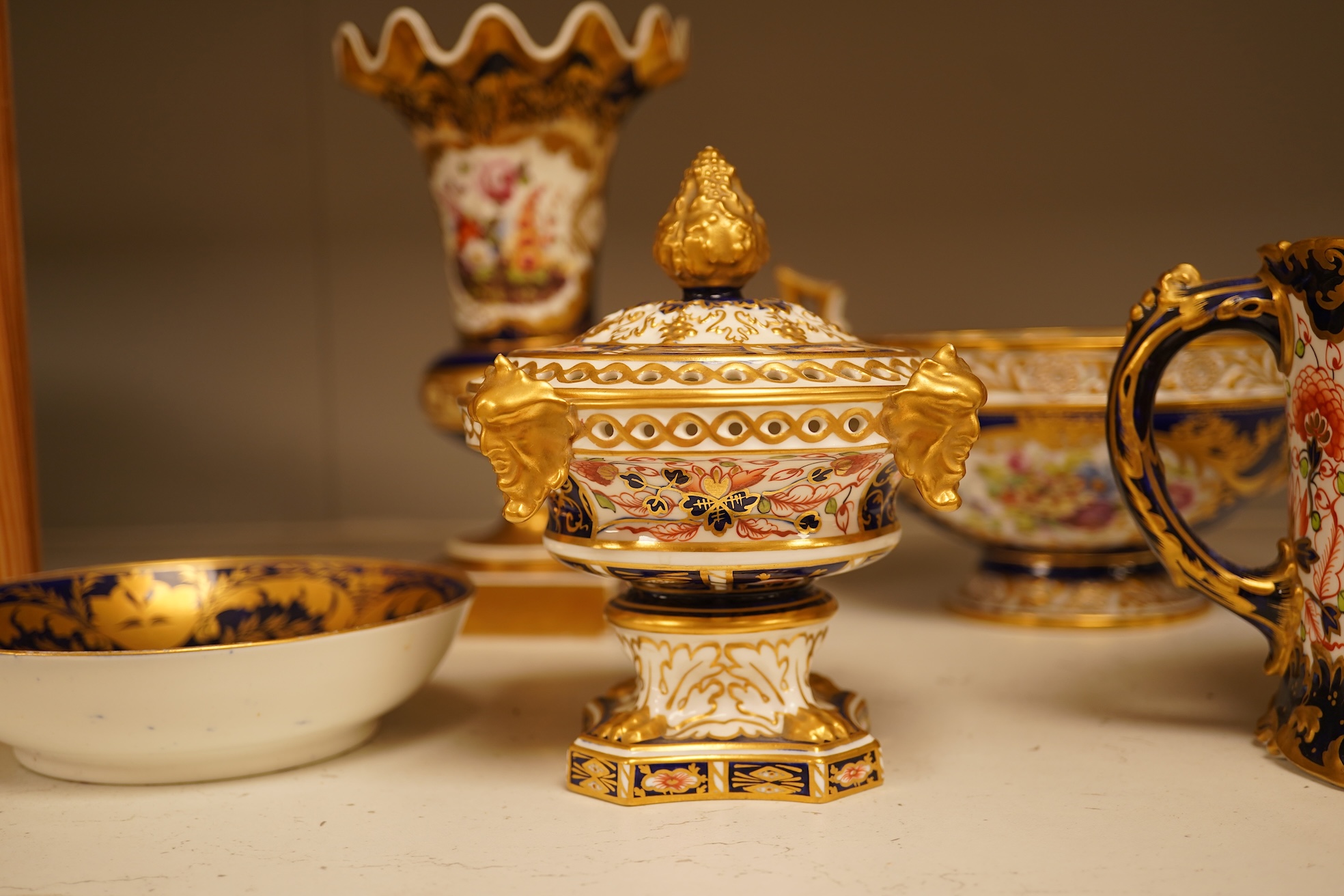 A collection of Royal Crown Derby, to include a two handled bowl, a fluted pedestal vase, saucer with landscape central cartouche etc (5). Vase 19cm high.